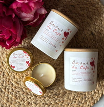 Load image into Gallery viewer, Amour du Cafe candles on a woven surface with pink flowers.