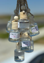 Load image into Gallery viewer, The Cali Glow scent shown in a group of car diffusers from the Coastal Collection