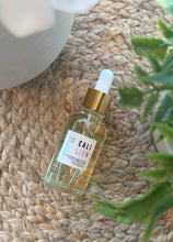 Load image into Gallery viewer, The Cali Glow Car Diffuser Refill in a 50 ml glass bottle with dropper.