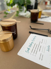 Load image into Gallery viewer, Candle-making materials on a table with a notecard for a guide.