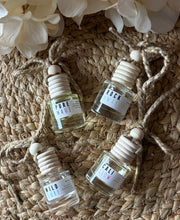 Load image into Gallery viewer, 4 Car diffusers in a small apothecary bottles in different scents on a woven mat