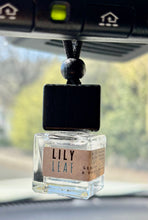Load image into Gallery viewer, A car diffuser hanging from rearview mirror in Lily Leaf Scent from the Kitchen collection