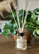 Load image into Gallery viewer, The Cedar & Forest scent in a reed diffuser, showing it in use with wood reeds from the Cascade Collection.