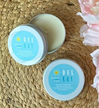Load image into Gallery viewer, Two travel candle tins with a blue label in the Del Ray scent on a woven surface with flowers.