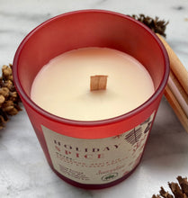 Load image into Gallery viewer, Close-up of the wood wick on Bungalow's Holiday Spice Winter Candle in a frosted red jar.