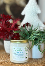 Load image into Gallery viewer, The Inland Empire Rustic Pine scent in a glass jar with gold lid from Bungalow's Winter Candle Collection.