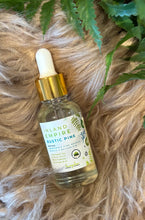 Load image into Gallery viewer, Bottle of Inland Empire Rustic Pine diffuser oil on a textured surface with green leaves.