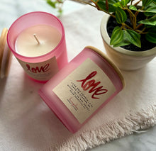Load image into Gallery viewer, Two frosted pink candle jars with a label showing it is the LOVE scent.