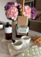 Load image into Gallery viewer, A Bungalow car diffuser in the Linen & Leaf scent.