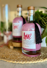 Load image into Gallery viewer, A recyclable glass apothecary jar of LOVE Luxe Bubble Bath with a wood cork stopper, containing pink bubble bath. The label has the brand name 'LOVE' written in a decorative font, and the product is part of the Valentine's & Mother's Day Collection.