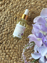 Load image into Gallery viewer, Glass bottle with eye dropper lid in the scent of Manito Park High Noon Blooms sitting on a textured mat.