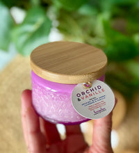 Load image into Gallery viewer, The Orchid & Vanille scent from Bungalow's Classic Collection shown in the cute 4oz purple-colored embossed jar.