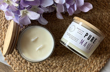 Load image into Gallery viewer, Large candle and jar labeled 'PURE MAUI' on a woven mat with purple flowers.