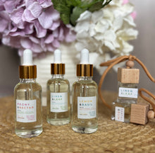 Load image into Gallery viewer, Three car diffuser refills and two car diffusers shown together from the Classic Collection.