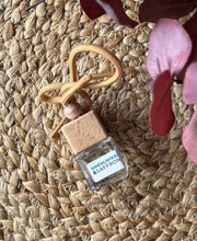 Load image into Gallery viewer, A Bungalow car diffuser in the Sandalwood & Saffron scent on a woven mat.