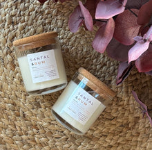Load image into Gallery viewer, 2 Santal & Rum mini 4 oz candles from the Classic Collection next to each other on a woven mat