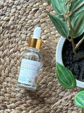 Load image into Gallery viewer, Glass bottle with eye dropper lid in the scent of South Hill Sangria on the Patio, sitting on a textured mat.