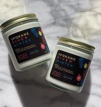 Load image into Gallery viewer, The Spokane River Winter scent in a glass jar with gold lid from Bungalow's Winter Candle Collection.