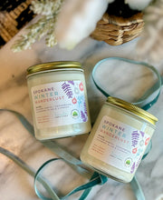 Load image into Gallery viewer, The Spokane Winter Wanderlust scent in a glass jar with gold lid from Bungalow's Winter Candle Collection.