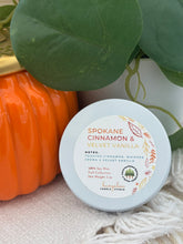 Load image into Gallery viewer, A mini candle in a white metal tin with the scent Spokane Cinnamon & Velvet Vanilla.