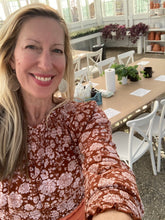 Load image into Gallery viewer, Woman taking a selfie in a room set for a candle making class.