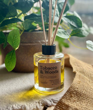 Load image into Gallery viewer, The Tobacco & Woods scent in a reed diffuser, showing it in use with wood reeds from the Cascade Collection.