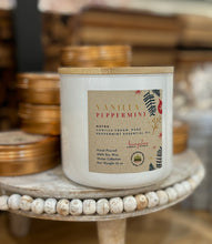 Load image into Gallery viewer, A vanilla peppermint soy candle in a white ceramic jar with a wooden lid.