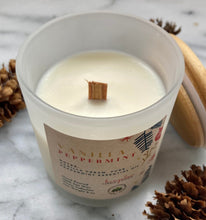 Load image into Gallery viewer, Close-up of the wood wick on Bungalow's Vanilla Peppermint Holiday Candle in a frosted white jar.