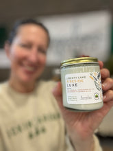 Load image into Gallery viewer, The Liberty Lake Fireside Luxe scent in a glass jar with gold lid from Bungalow's Winter Candle Collection.