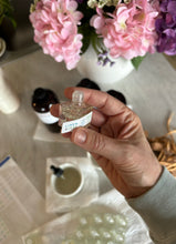 Load image into Gallery viewer, Holding individual car diffuser while putting on label