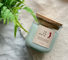 Load image into Gallery viewer, The scent, 19th Hole, from the Golf Collection is shown in the 8oz candle in glass jar with cork lid.