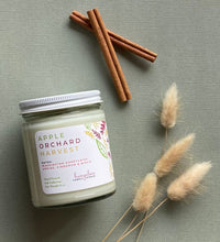 Load image into Gallery viewer, The Apple Orchard Harvest candle scent from Bungalow's Fall Collection is shown in the 8 oz glass jar with a white lid.