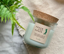 Load image into Gallery viewer, The scent, Fresh Cut Grass, from the Golf Collection is shown in the 8oz candle in glass jar with cork lid.