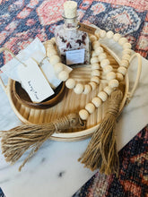 Load image into Gallery viewer, Natural Mango Wood Contentment Bead with Jute Tassels staged with bath salts