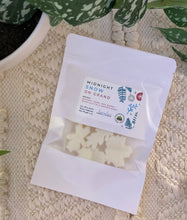 Load image into Gallery viewer, A white pouch of soy wax melts in the Midnight Snow on Grand scent laying flat on a woven mat.