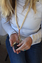 Load image into Gallery viewer, Sue, owner of Bungalow Candle Studio, wearing a mango wood bead teacher lanyard and holding her keys to show how they attach.