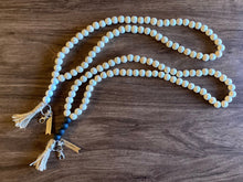 Load image into Gallery viewer, 2 wood bead lanyard with natural beige colored beads next to each other on a dark wood table--one with whitewash accent beads and the other with black matte