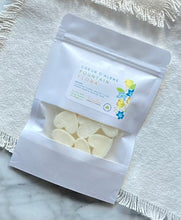 Load image into Gallery viewer, Heart-shaped Soy Wax Melts from the Bungalow Spring and Summer Collection in a white sealed package with a window in the Coeur d'Alene Fountain Flora scent.