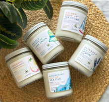 Load image into Gallery viewer, Group of Bungalow Seattle Collection soy wax candles that are 8oz size in glass jars with white tin lids

