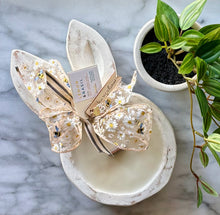 Load image into Gallery viewer, Hand-carved bunny shaped wood dough bowls candle with whitewash finish, adorned with ribbon, and tagged with scent information for Lemon &amp; Basil.
