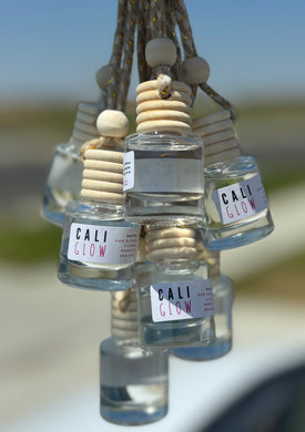 The Cali Glow scent shown in a group of car diffusers from the Coastal Collection