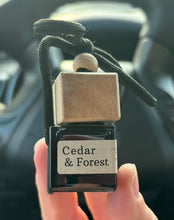 Load image into Gallery viewer, The Cedar &amp; Forest scent from the Cascade Collection in a car diffuser.
