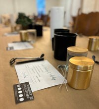 Load image into Gallery viewer, Table space set with jars and instructions for a candle-making class

