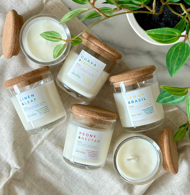 Mini 4 oz candles in scents from the Classic Collection grouped together .