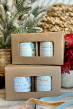 Load image into Gallery viewer, Two cardboard gift boxes with open windows, displaying multiple 2 candles inside. The boxes are presented on a white marble surface with a winter greenery in the background.
