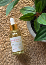 Load image into Gallery viewer, Bottle of Guava &amp; Gardenia scented oil with dropper on a textured surface with a plant in the background
