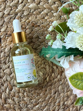 Load image into Gallery viewer, Glass bottle with eye dropper lid in the scent of High Drive Bluff in Springtime, sitting on a textured mat.
