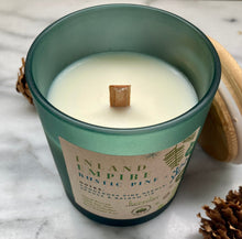 Load image into Gallery viewer, Close-up of the wood wick on Bungalow&#39;s Inland Empire Rustic Pine Holiday Candle in a frosted green jar.
