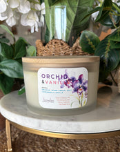 Load image into Gallery viewer, Extra-large 24 oz soy candle with wooden lids in the Orchid &amp; Banille scent, sitting on a marble table.
