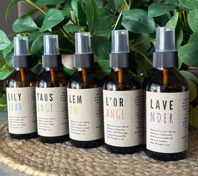 Linen Sprays from the Kitchen Collection lined up in a row to showcase titles.